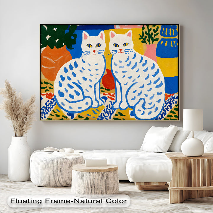 The focal point of this colorful folk cat canvas wall art is the two white cats adorned with blue markings, creating a playful Scandinavian-style scene.