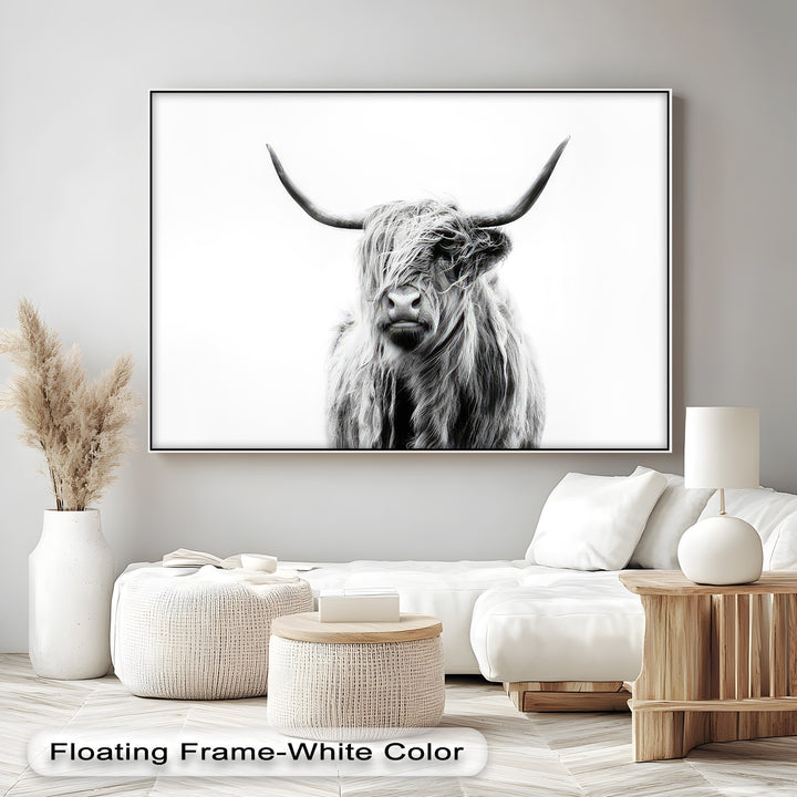 A striking black and white Highland Cow canvas artwork, featuring shaggy fur and curved horns against a bright white background.