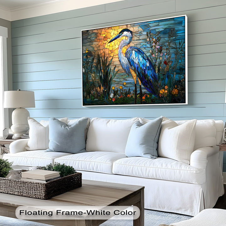 Plush white and pale blue pillows on a cozy sofa frame a vibrant stained glass heron big canvas prints, creating a serene, inviting atmosphere.