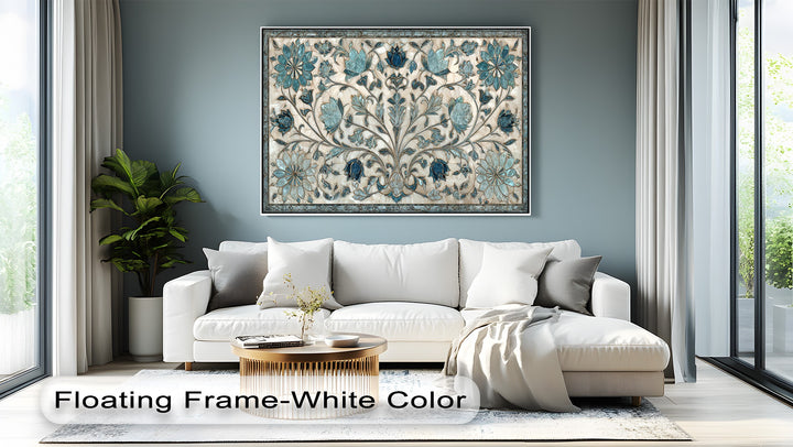 The serene, muted blue-grey wall serves as a tranquil backdrop for the elegant blue floral ornament framed canvas.