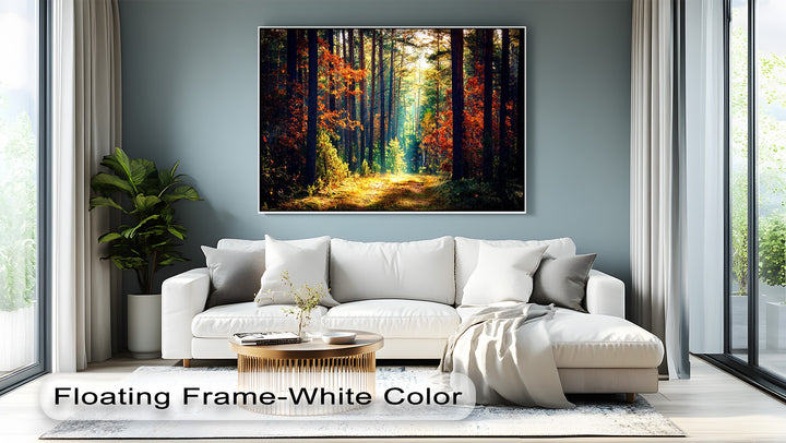 A plush white sofa, modern gold coffee table, and soft rug fill the foreground, highlighting the vivid autumn forest canvas art.