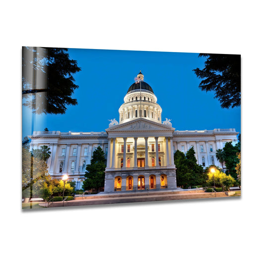 Strong color contrast highlights the California State Capitol Building, a landmark rendered in beautiful art from glass, showcasing its iconic architectural details against a deep twilight sky.