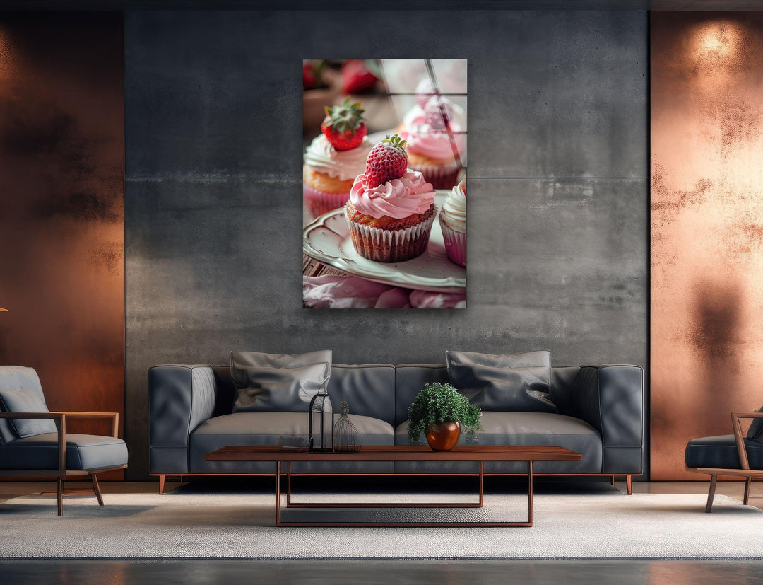 Striking color contrast highlights the Strawberry Cupcakes glass wall art, a piece of unique modern wall decor, with its vibrant pink frosting against the muted background.