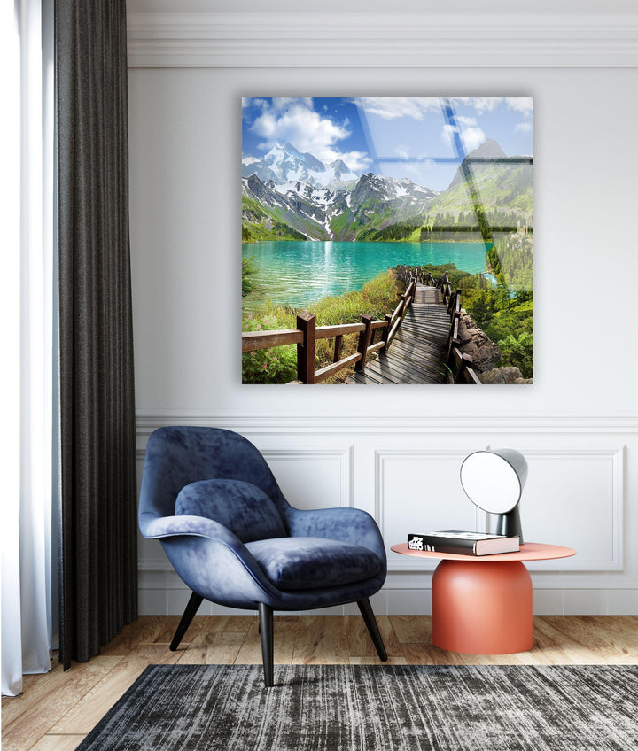 Panoramic lake view with a vibrant blue sky, reflecting in crystal-clear waters.
