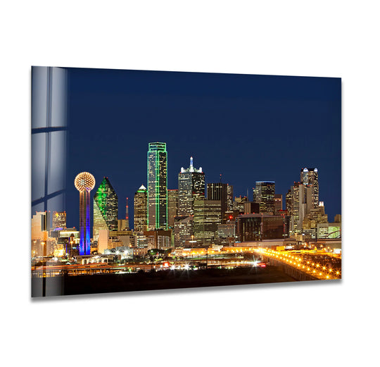 Illuminated Dallas skyline cityscape is the central subject of this stunning glass wall art decor, showcasing iconic landmarks and nighttime reflections.