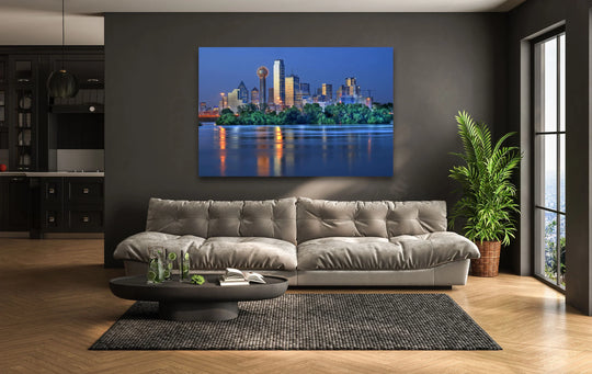Reflecting off the water, the dallas skyline at night is the loudest element in this home decoration of cityscape wall art.