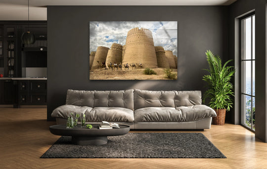 With warm color temperature, this glass wall art wall prints depicts the historic Derawar Fort and camel caravan against a clouded desert sky.