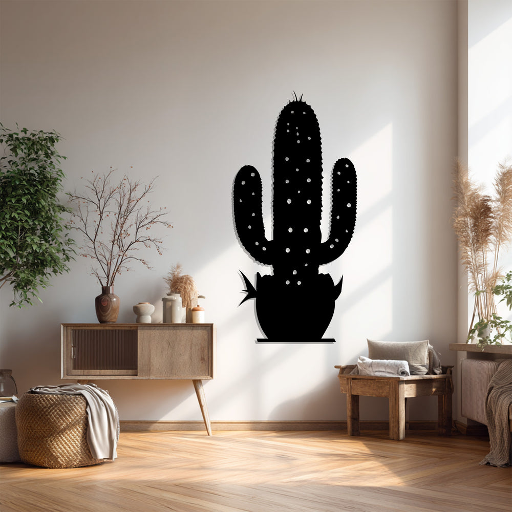 Alternating the sleek, dark cactus figure on the wall with bright interior elements creates a striking visual rhythm in this metal art for wall piece.