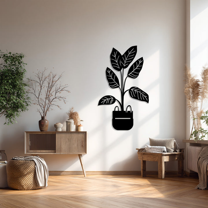 Foreground shows the elegant lines of the potted plant decoration wall art, a minimalist metal botanical piece, adding a modern touch to the room's decor.
