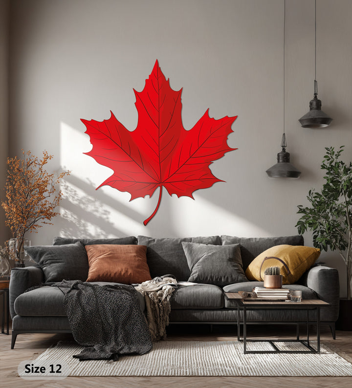 Negative space highlights the unique metal wall art in this red maple leaf design, creating a striking piece of Canadian nature-inspired wall decor.