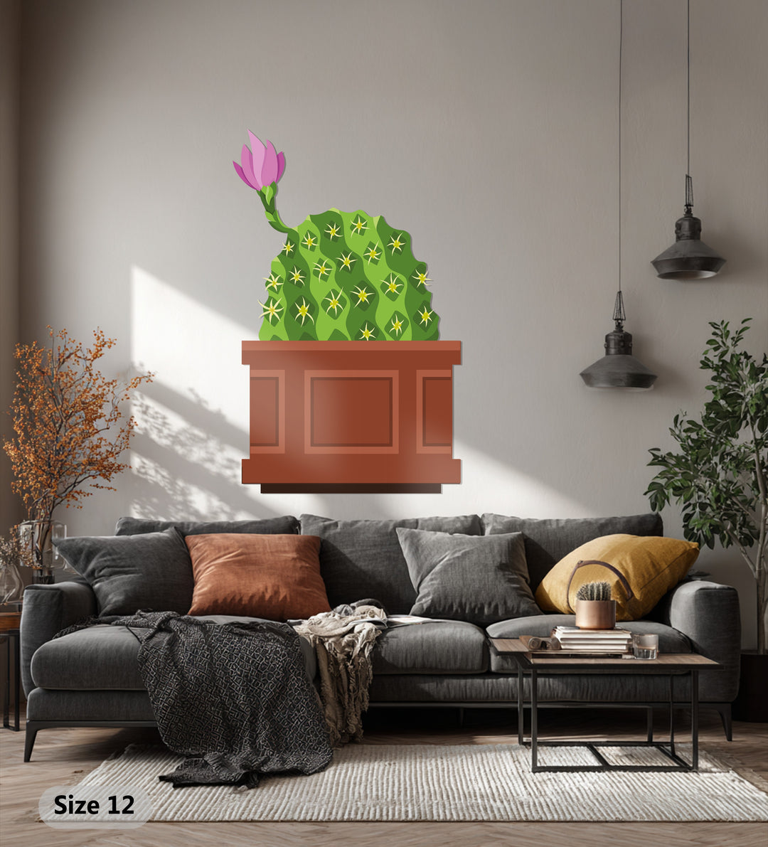 Sunlight casts dramatic light and shadow patterns around this metal decoration wall art of a blooming pink cactus, adding depth to its botanical form.