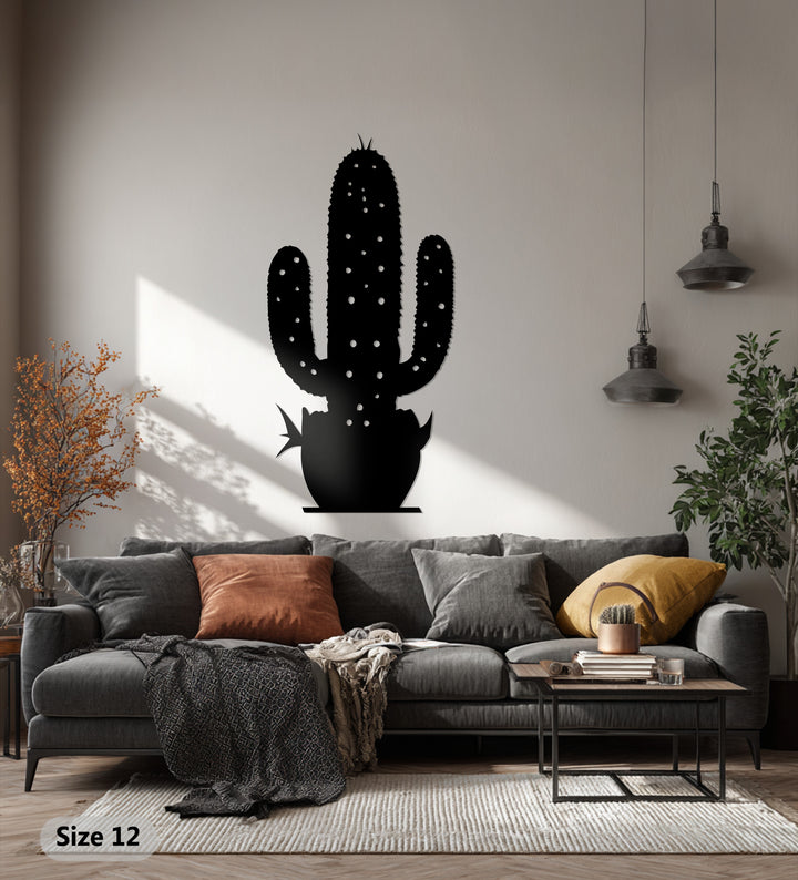 Repetitive shapes create a pleasant visual rhythm in this cactus metal art for wall, a desert botanical sculpture casting soft shadows above a modern sofa.