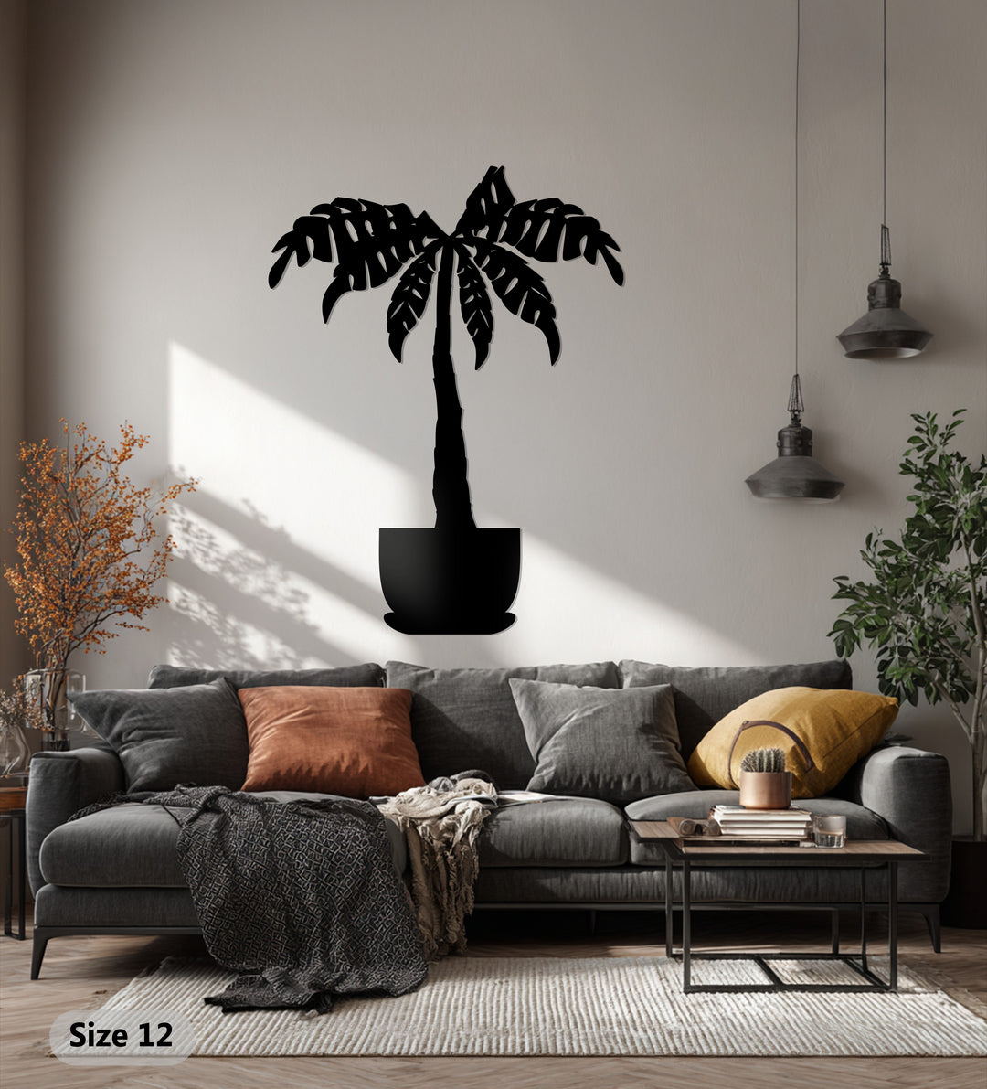 Outlining the organic forms of decorative metal art, a tropical palm tree is depicted with stylized fronds in this botanical wall decor piece.