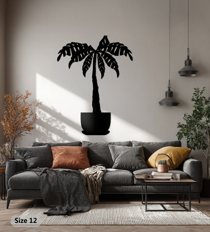 Outlining the organic forms of decorative metal art, a tropical palm tree is depicted with stylized fronds in this botanical wall decor piece.