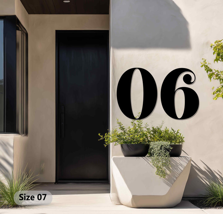 Mounted on a textured wall, the boldly sized '06' metal numbers offer eye-catching decoration wall art, creating a vintage-inspired outdoor address display with elegant curves.