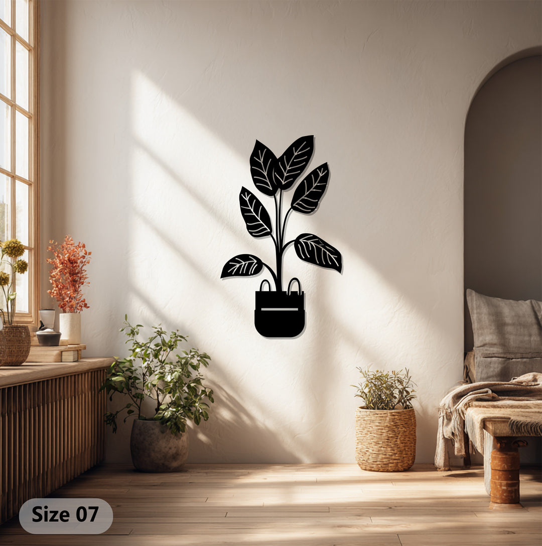 Shadows define the softest light across the minimalist, botanical modern potted plant metal art for wall, enhancing the decorative piece's simple charm.
