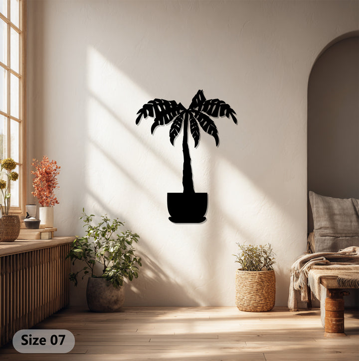 The shadow play accentuates the dynamic presence of the metal art for wall, making the tropical palm tree design sway gently in the imagined breeze.