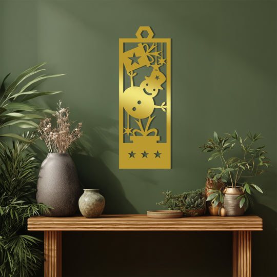 Warm tones highlight the gold color of this joyful snowman Christmas stars metal wall decor against the cooler green backdrop, creating a cozy contrast.