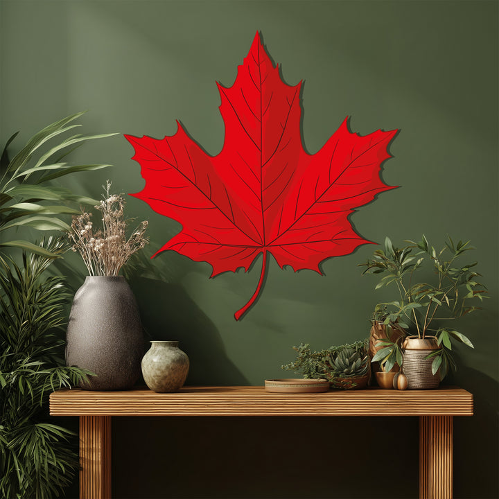 Highlighted by the brightness, a red maple leaf metal artwork brings nature-inspired home decoration to this stylish, shadowed interior scene.