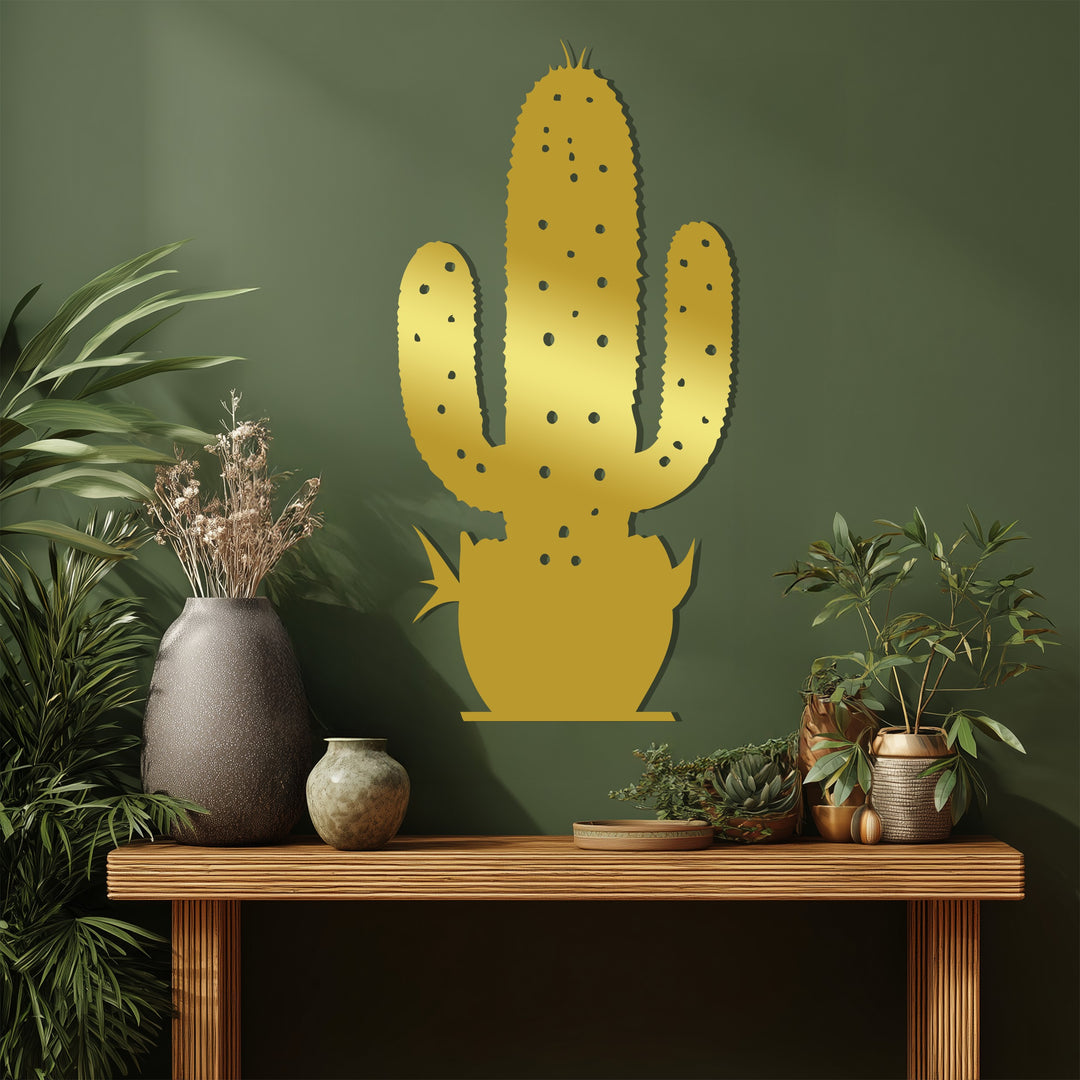 The decorative metal art of a gold cactus makes a desert botanical focal point against a muted green wall, bringing a modern touch to any room.