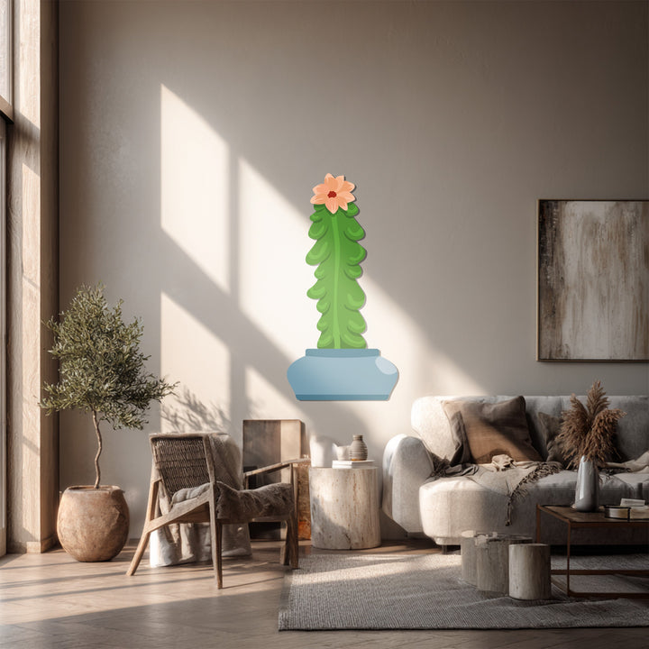 Sunlight highlights the soft texture of the cactus, contrasting with the modern Column Cactus metal wall decor, an ideal piece of metal wall decor for a minimalist space.