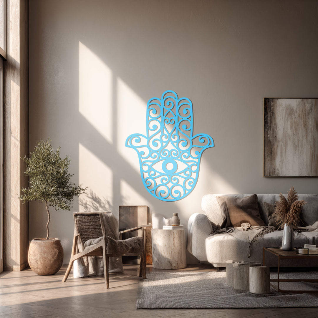 Sunlit walls and stylish living room furniture complement the captivating hamsa hand metal artwork, enhancing the neutral-toned background.