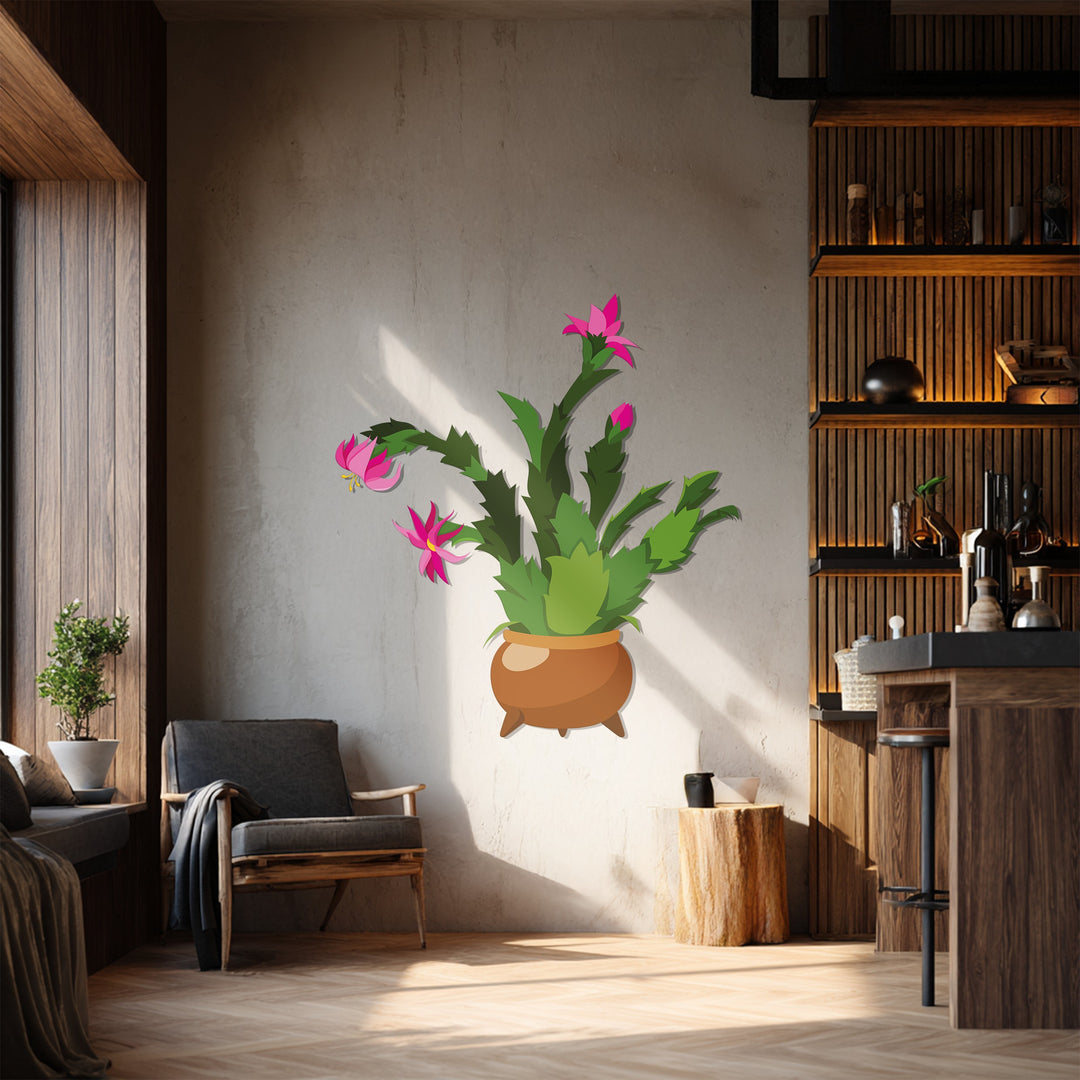 The blooming pink cactus, a piece of metal art for wall, is a modern botanical decor showcased in a brown pot with spindly legs.
