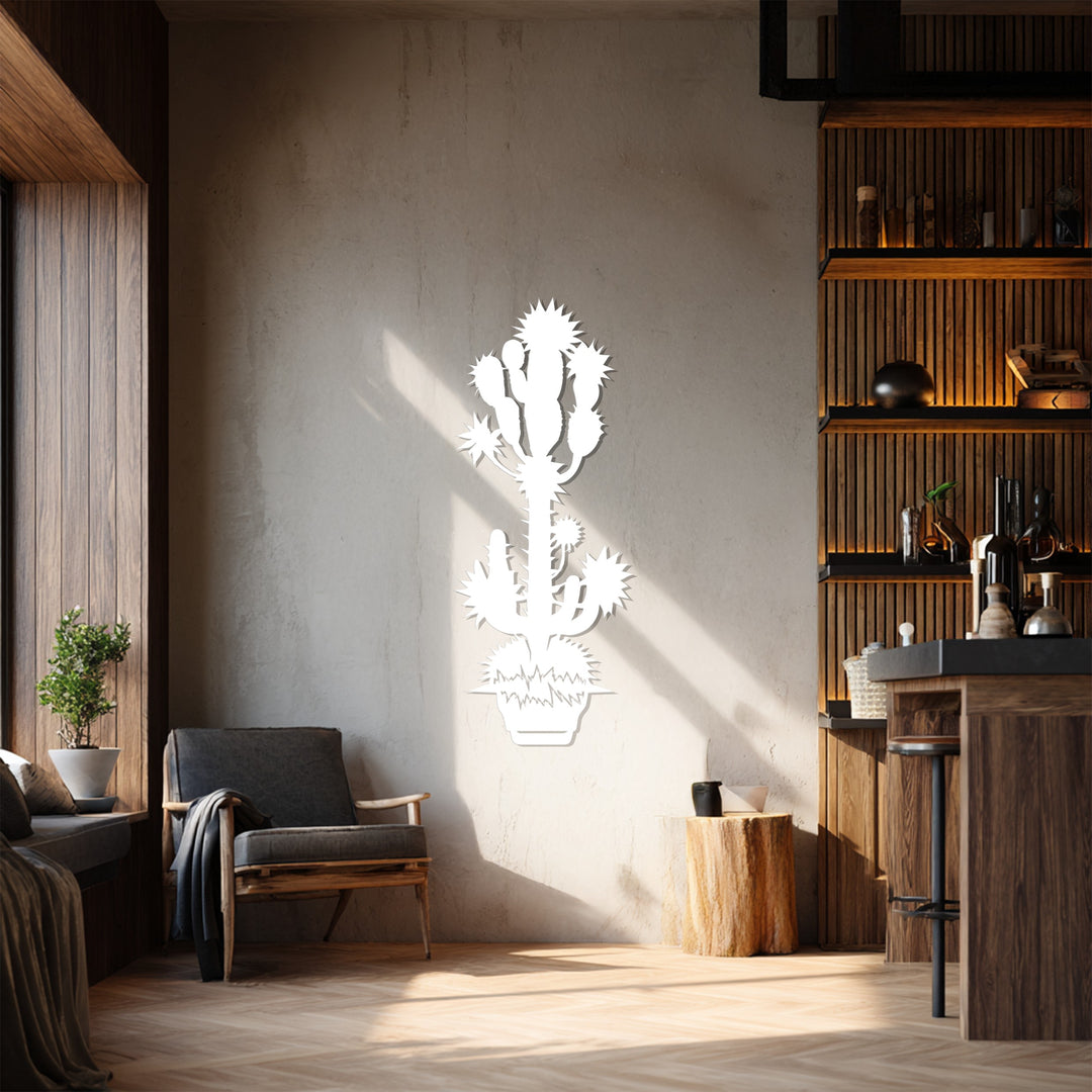Subtle shadows around the spiky desert cactus define the softest element of this bold botanical metal wall decor, a modern addition to any interior.