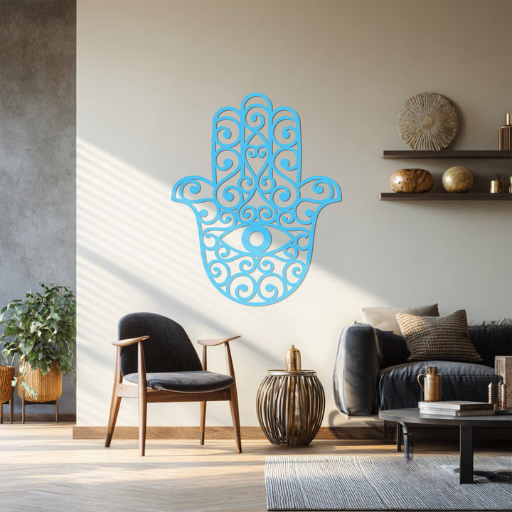 Azure is the dominant color of this hamsa hand metal wall art, showcasing detailed scrollwork and the iconic evil eye as a spiritual metal artwork.