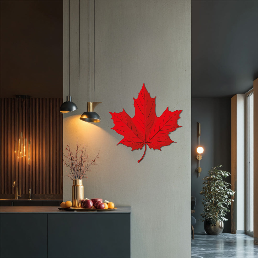 Shadowy recess highlights the intricate laser-cut details of this red maple leaf, a modern metal artwork adding a touch of Canadian nature-inspired home decor.