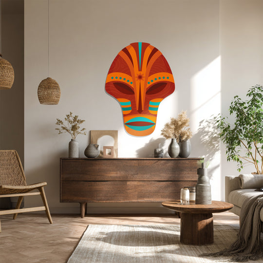 Negative space defines the orange and turquoise tribal mask, creating a striking contrast within this piece of metal art for wall.