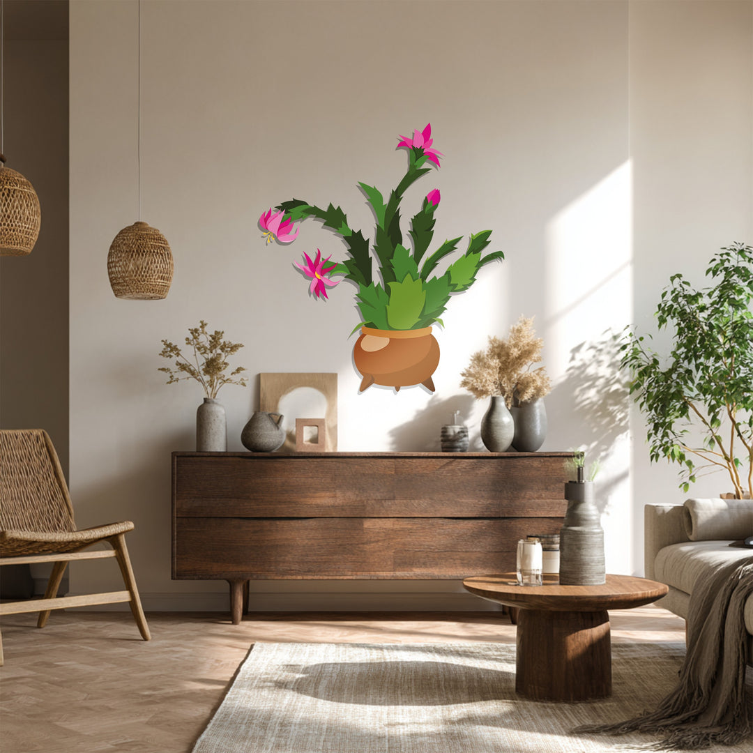 Subtle light graces the wall behind the blooming pink cactus, highlighting the delicate forms of this botanical metal art for wall.