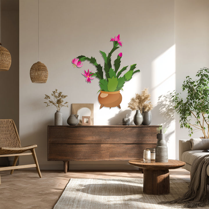 Subtle light graces the wall behind the blooming pink cactus, highlighting the delicate forms of this botanical metal art for wall.