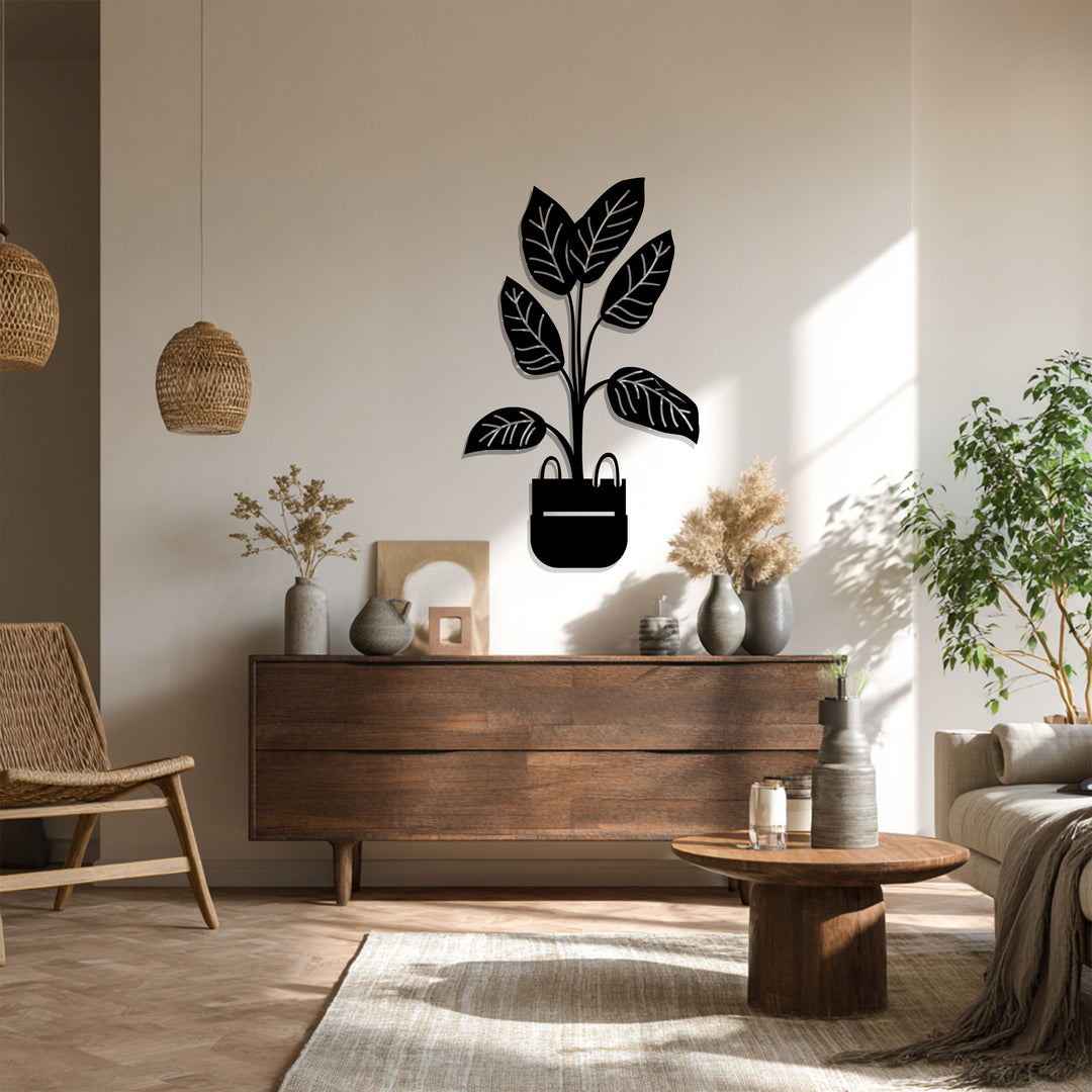 Shadows define the decorative metal art of this modern potted plant metal wall art, a minimalist botanical decor piece that softens the light in a room.
