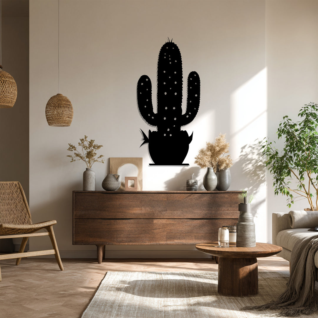 Shadows accentuate the metal wall decor of a modern cactus, showcasing the seamless transition between light and dark tones in a desert botanical form.