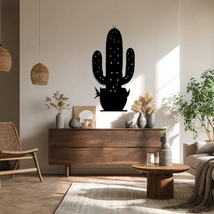 Shadows accentuate the metal wall decor of a modern cactus, showcasing the seamless transition between light and dark tones in a desert botanical form.