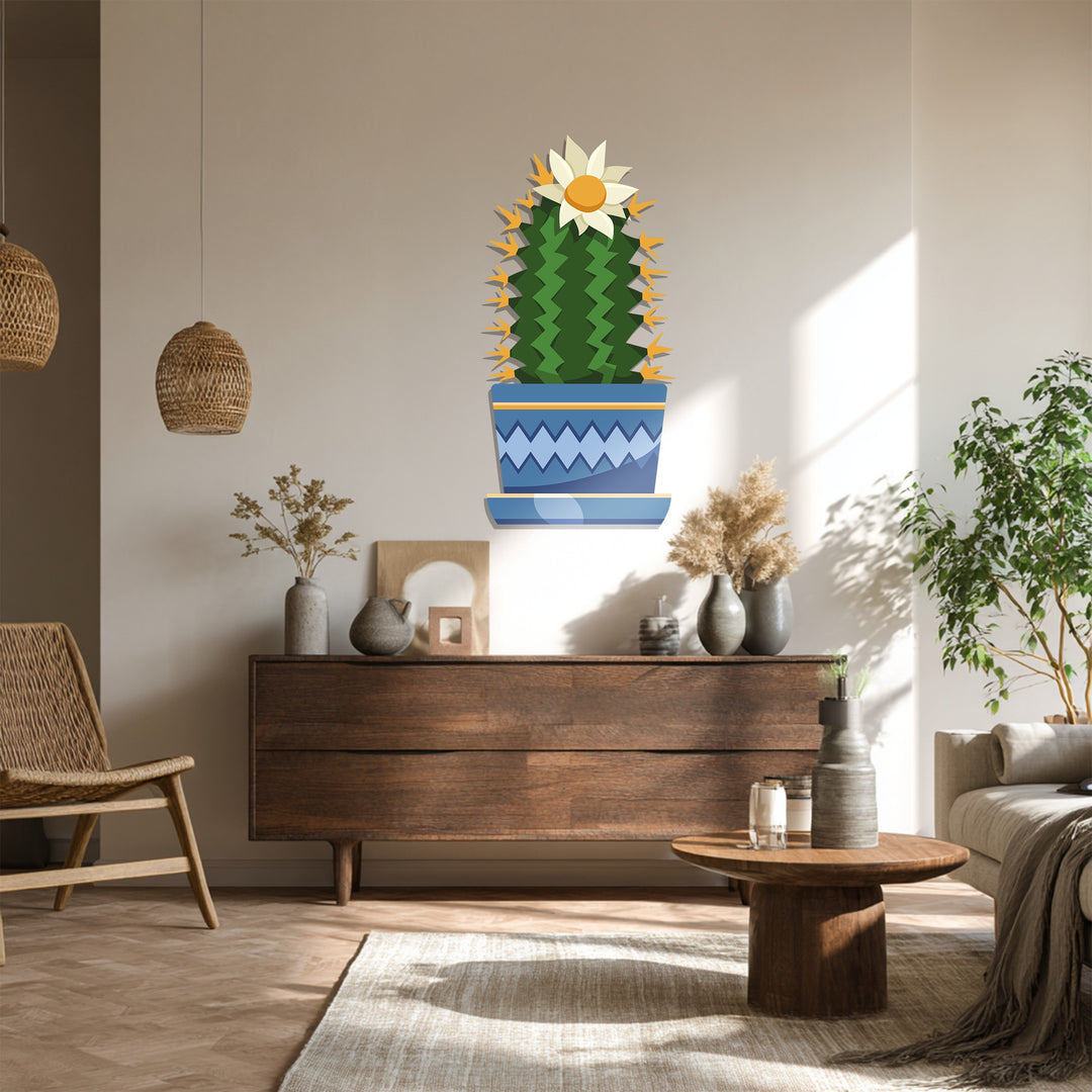 Illuminated by sunshine, this botanical-themed metal artwork shows a cactus with a flower in a decorative pot, offering a modern aesthetic for wall decor.