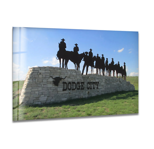 Negative space surrounds the Dodge City sign and cowboy silhouettes, highlighting the iconic landmark as a stunning example of tempered glass wall art.