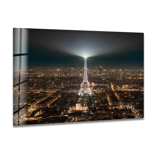 The abstract quality of this Eiffel Tower glass printing art highlights the illuminated Paris landmark against a shimmering cityscape at night.
