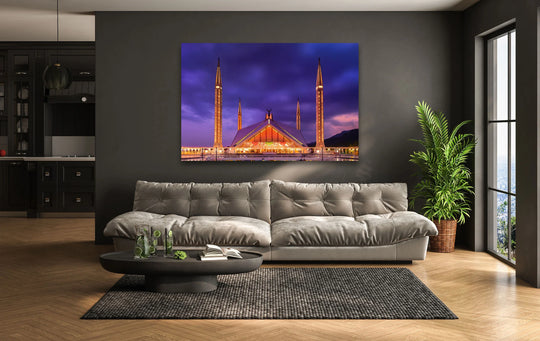 Dominant purples and golds highlight the illuminated Faisal Mosque at night in this striking piece of wall art prints.
