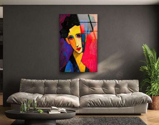 A close-up view of figurative abstract woman glass wall art decor with bold colors and sharp lines.