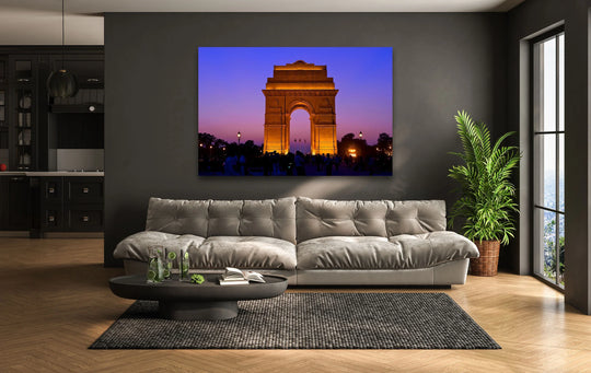 Warm color temperature illuminates the India Gate glass wall art prints, contrasting against the cool, twilight sky in this captivating city print.