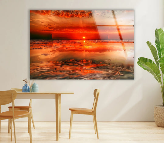 Negative space surrounds the fiery sunset shoreline decorative wall art, highlighting the bright colors of the ocean glass print.