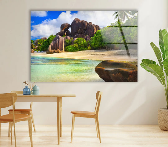 Expansive negative space surrounds the granite coastline wall art, highlighting the immersive detail of this lush tropical beach scene with expert glass printing.