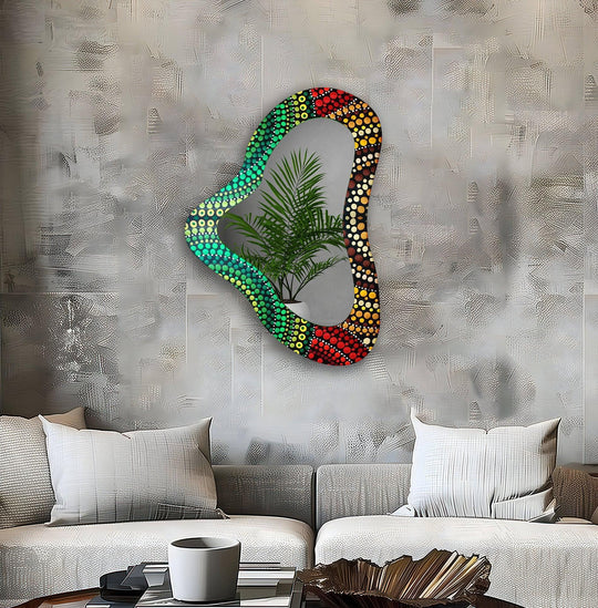 Reflecting the stillness of nature indoors, a striking irregular shaped framed wall mirror captures a verdant plant within its mosaic design, a quiet study in contrasts.