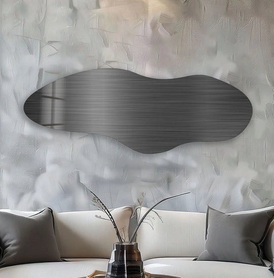 The brightest area of the abstract glass wall art features a wave-like shape against a textured backdrop.