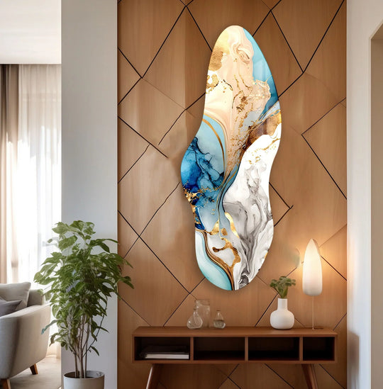 An irregular asymmetrical golden blue glass wall art showcases a mesmerizing layering effect of abstract swirls and metallic accents.