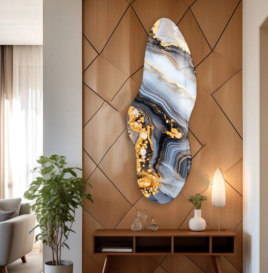 An abstract glass printing piece showcases a glossy surface texture with flowing navy and white marble swirls interspersed with textured gold accents.