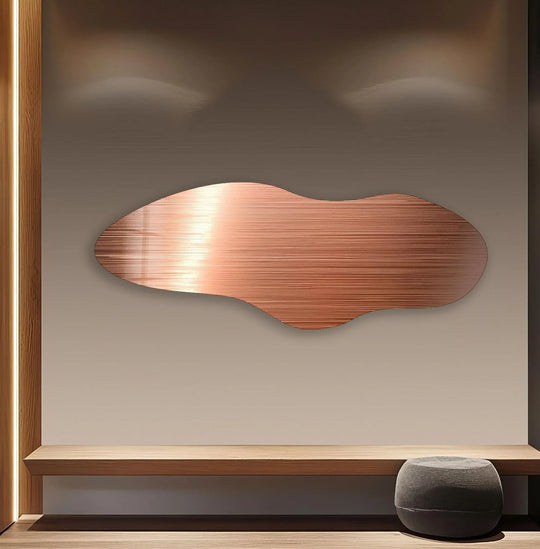 Bronze irregular glass wall artwork floats in negative space, enhanced by ambient lighting.