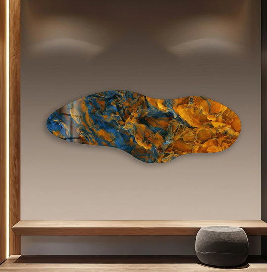 Dominant orange and blue swirls create a dynamic abstract scene on this vivid glass printing, perfect for modern interiors.